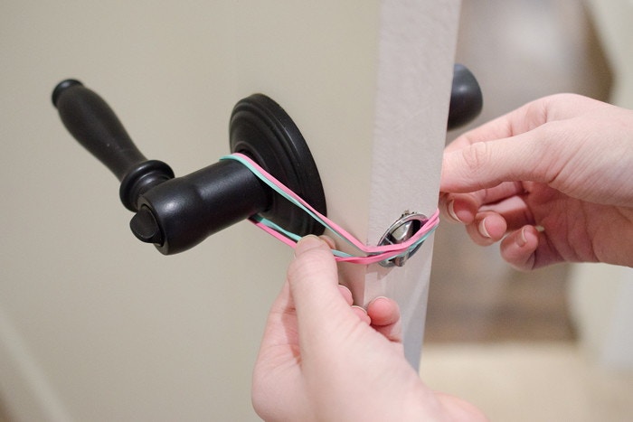 Keep doors from locking with rubber bands.