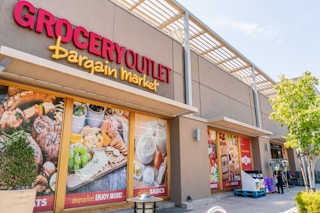 Grocery Outlet Bargain Market storefront with window decals showing deals.
