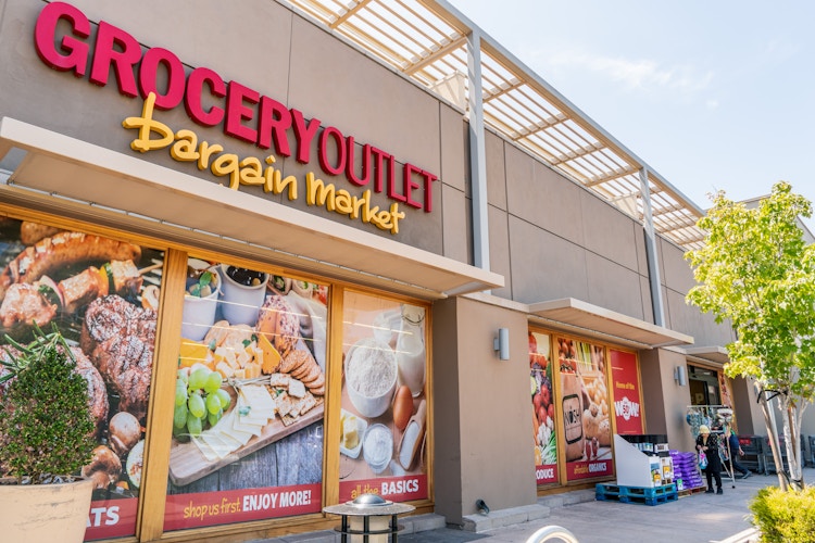 Grocery Outlet Bargain Market storefront with window decals showing deals.