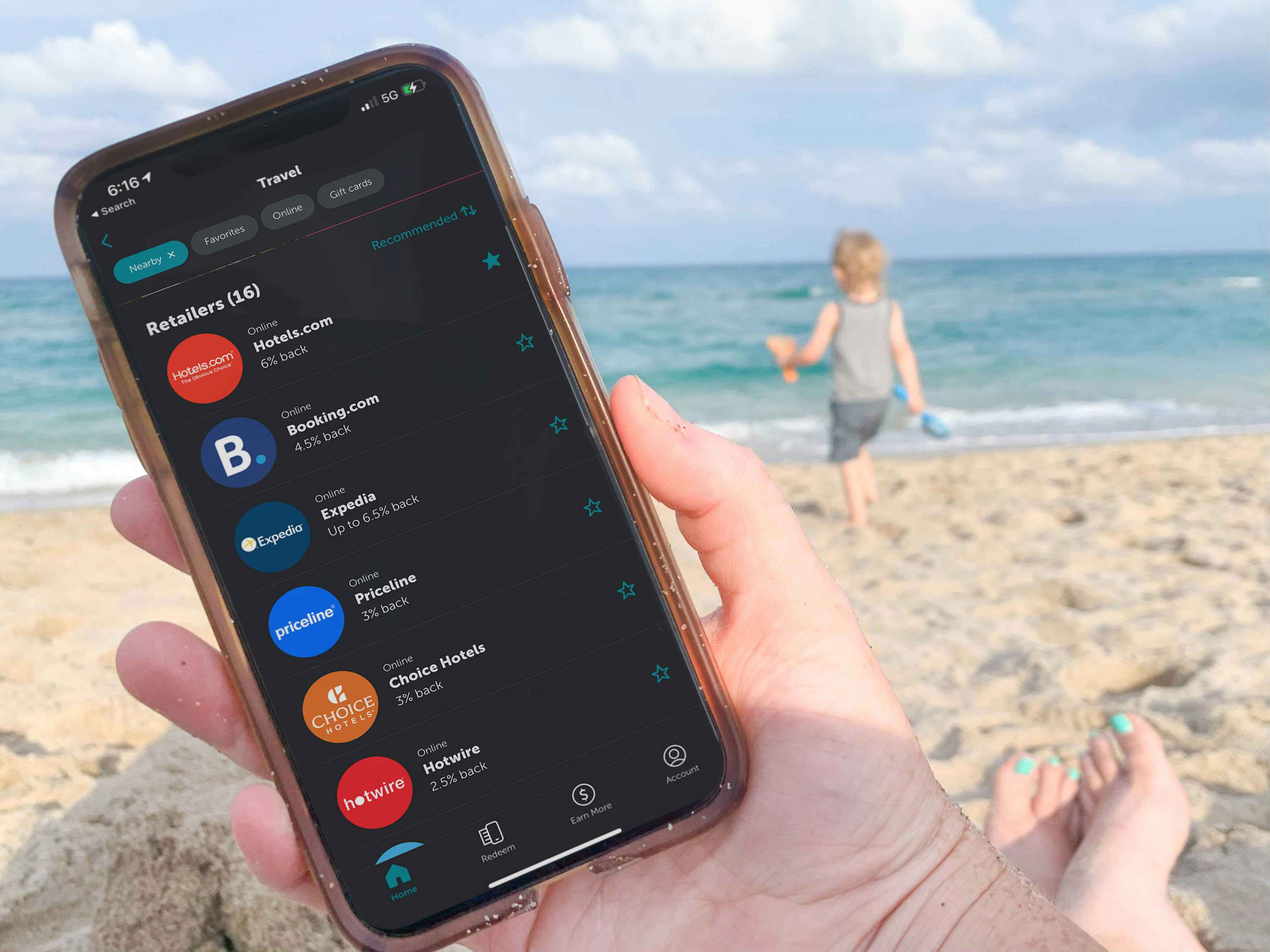 cellphone being held at the beach with the ibotta app