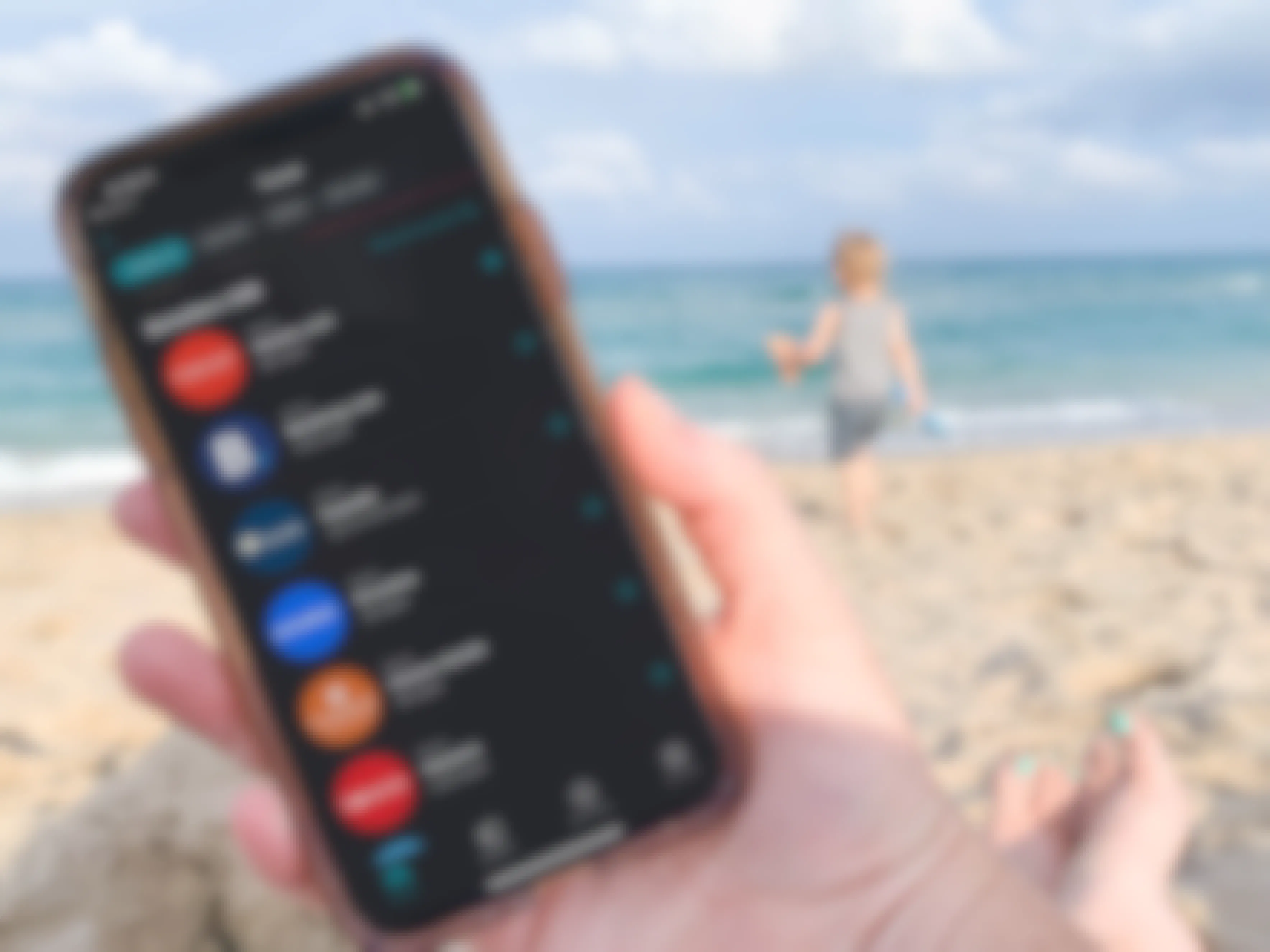 cellphone being held at the beach with the ibotta app