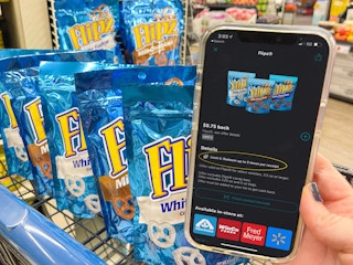 Ibotta app on a cell phone next to a cart filled with flipz