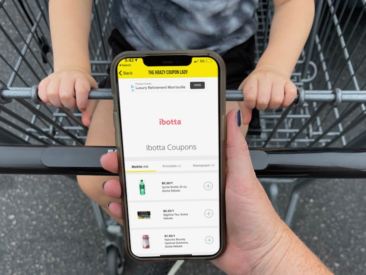 ibotta app being held in front of cart with child
