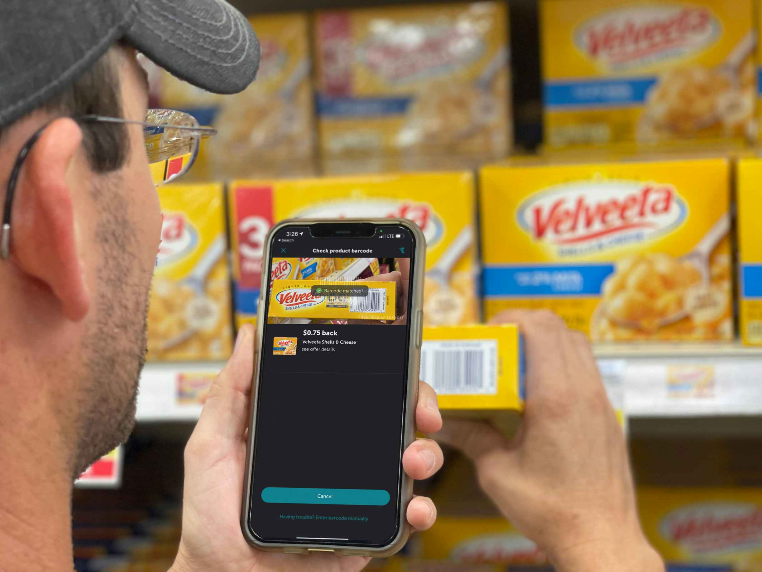 a person using cellphone to scan velvetta shells with ibotta app
