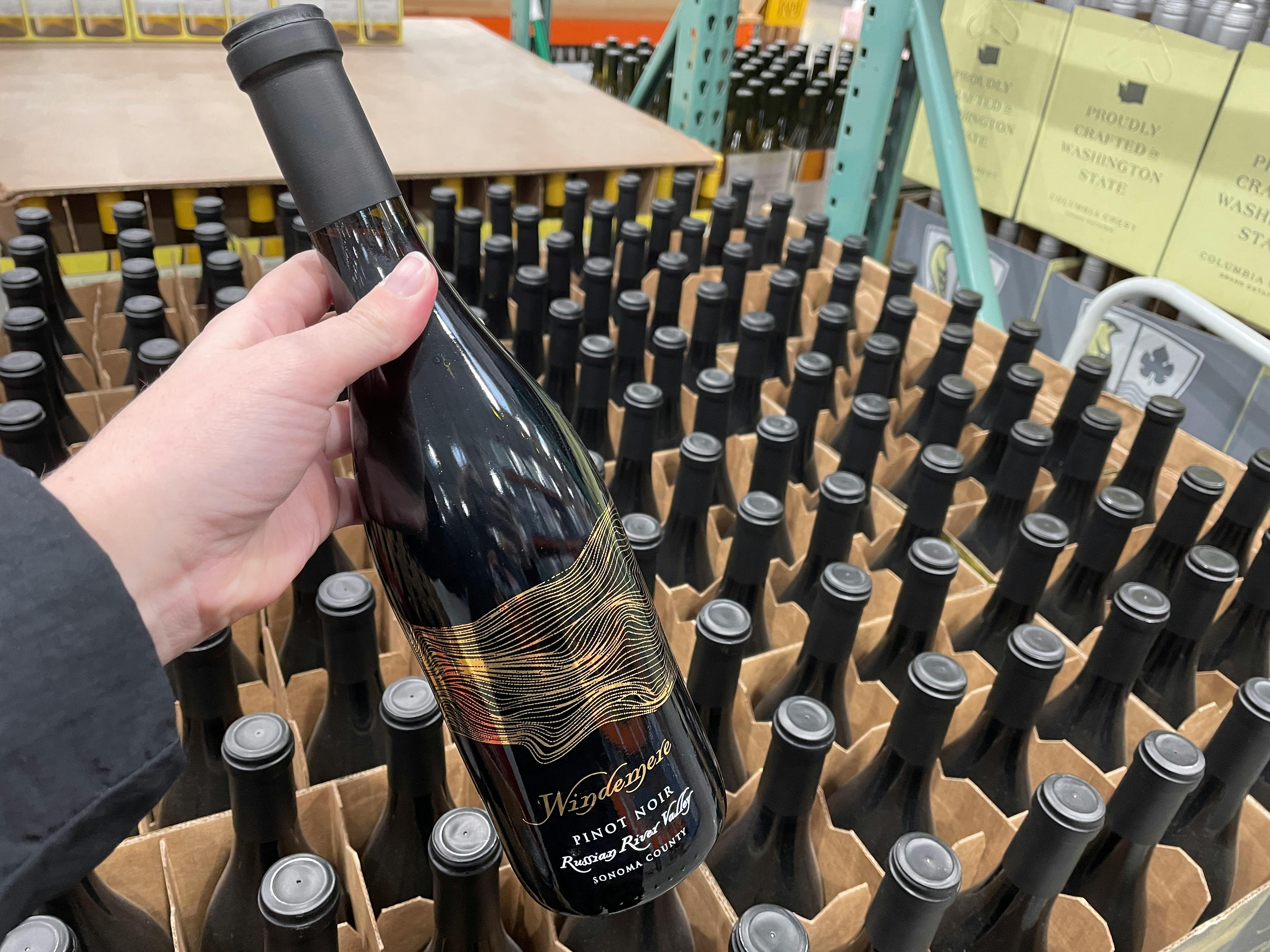 hand with windemere pinot noir bottle at costco