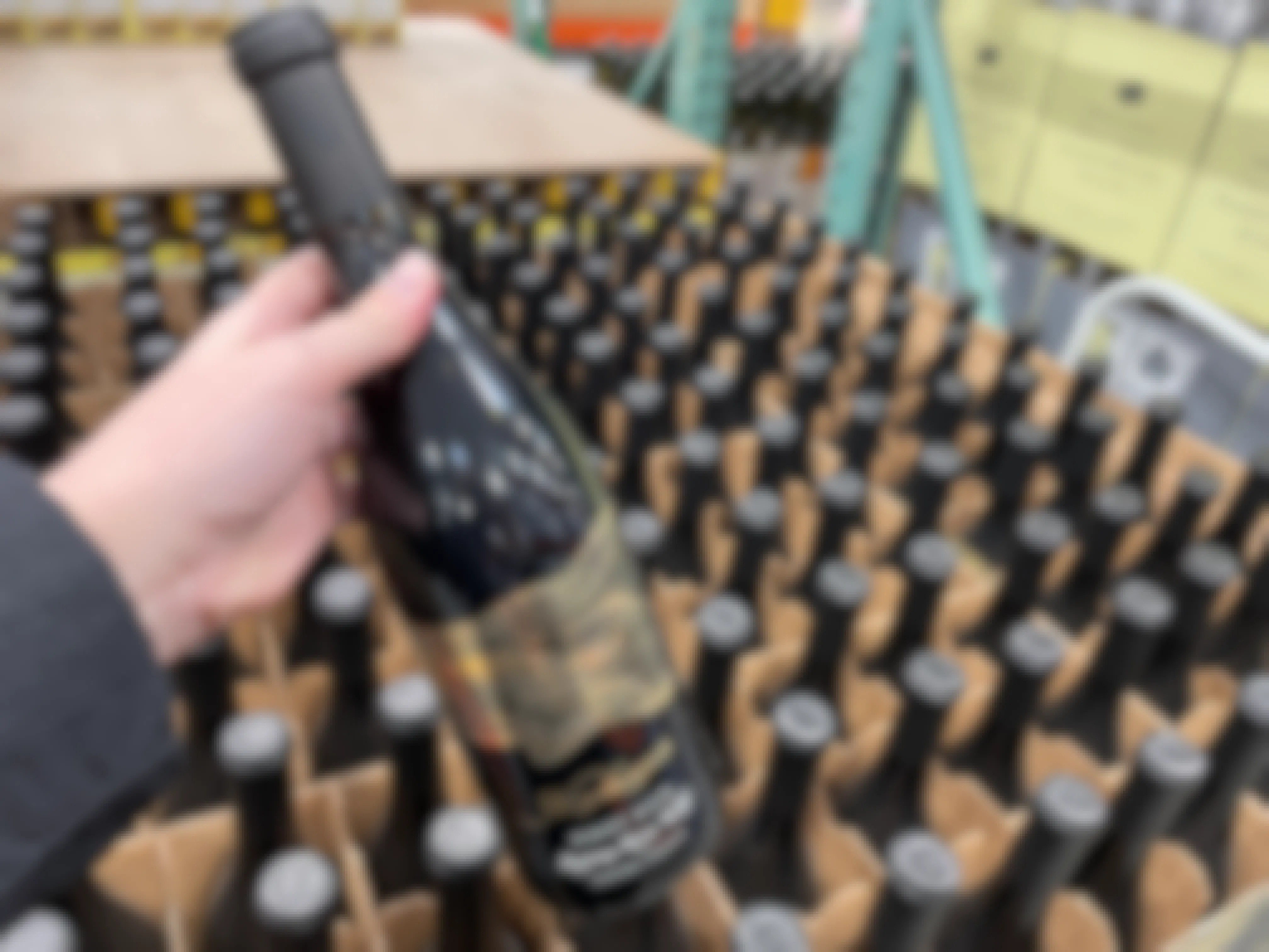 hand with windemere pinot noir bottle at costco