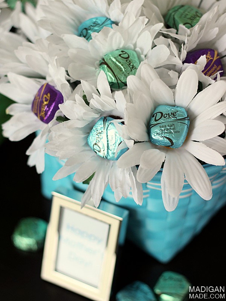 chocolates attached to the blossoms of fake flowers in a vase