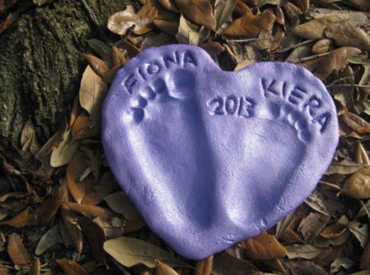 a purple clay heart with two children's footprints and year made