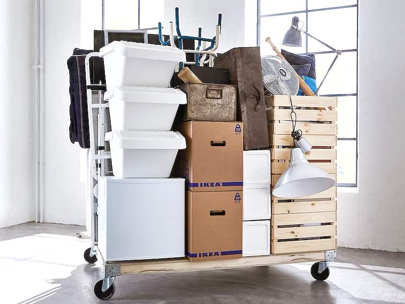 ikea totes, boxes, chairs, and laps on a rolling cart