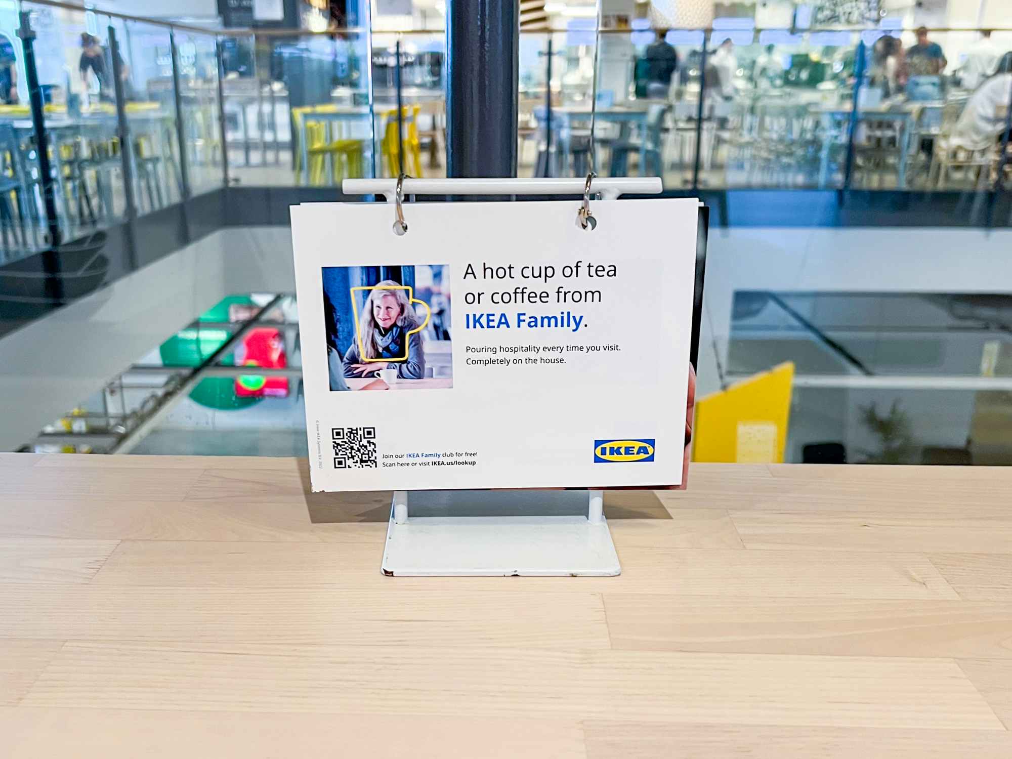 a sign advertising a free hot drink for Ikea Family members