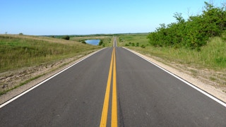 open highway with a double yellow line down the middle