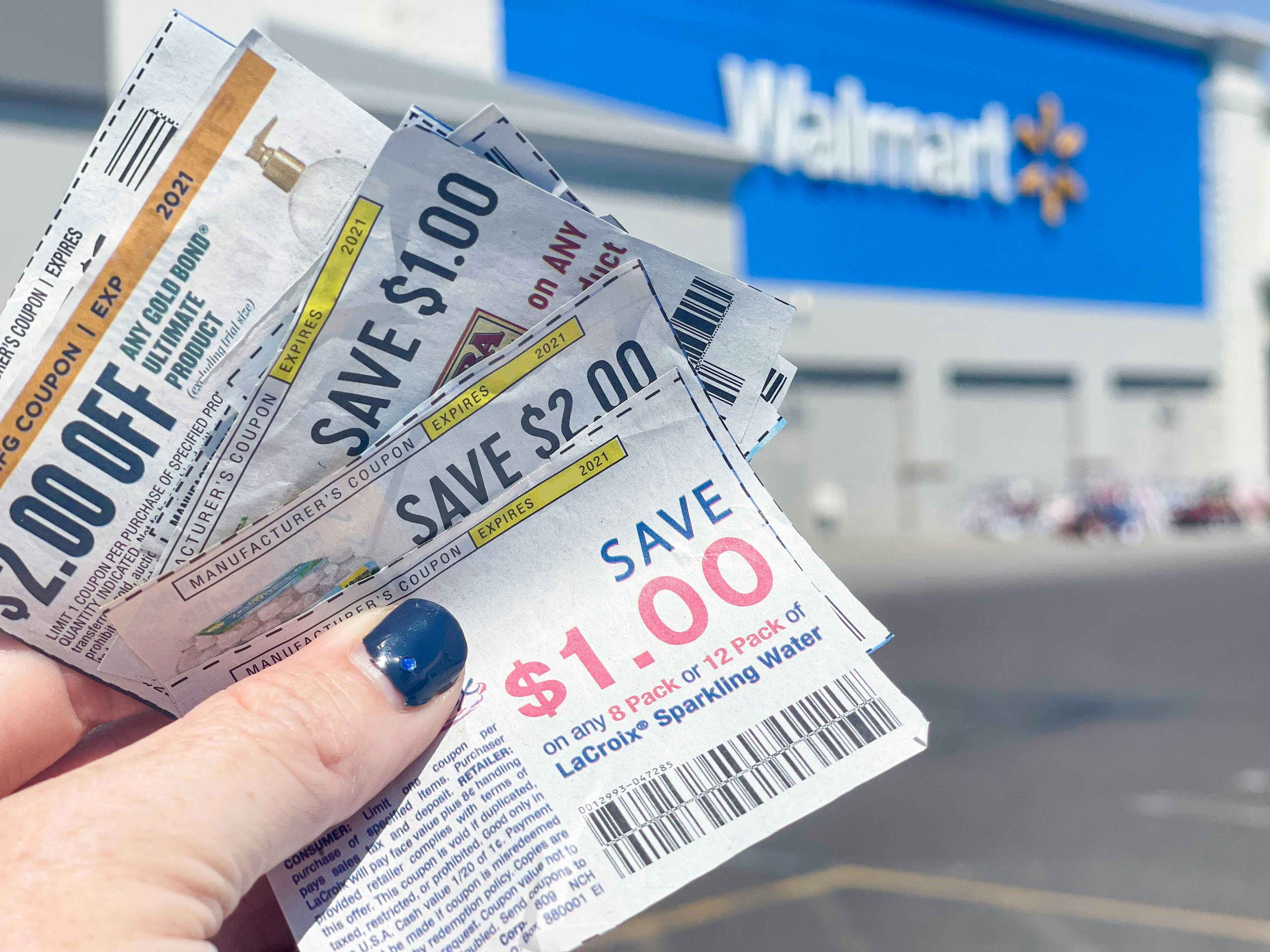 coupons held outside a walmart storefront