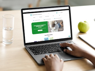 a person on kidsbook.com on their macbook