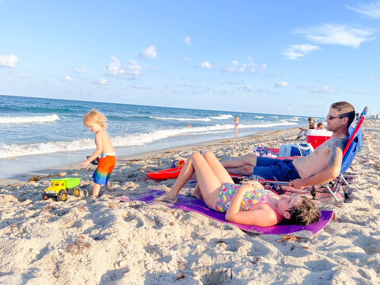 family playing and relaying at the beach