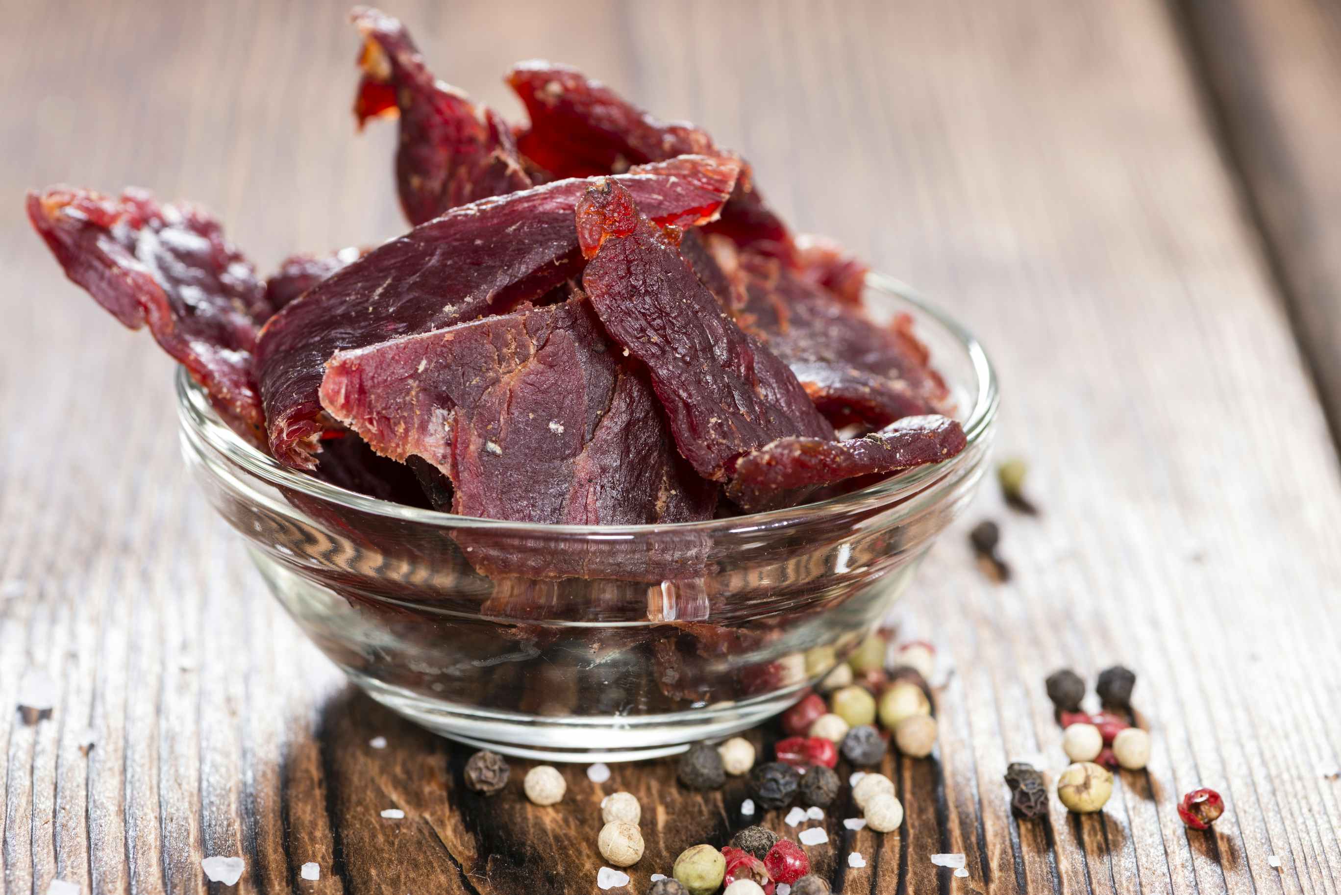 A bowl of homemade beef jerky on a table