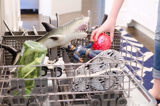 placing toys in the dishwasher to disinfect