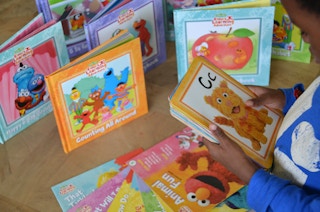 Small child looking at kids books.