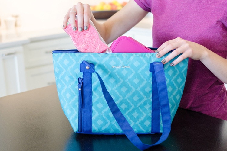 woman putting a sponge into a cooler bag