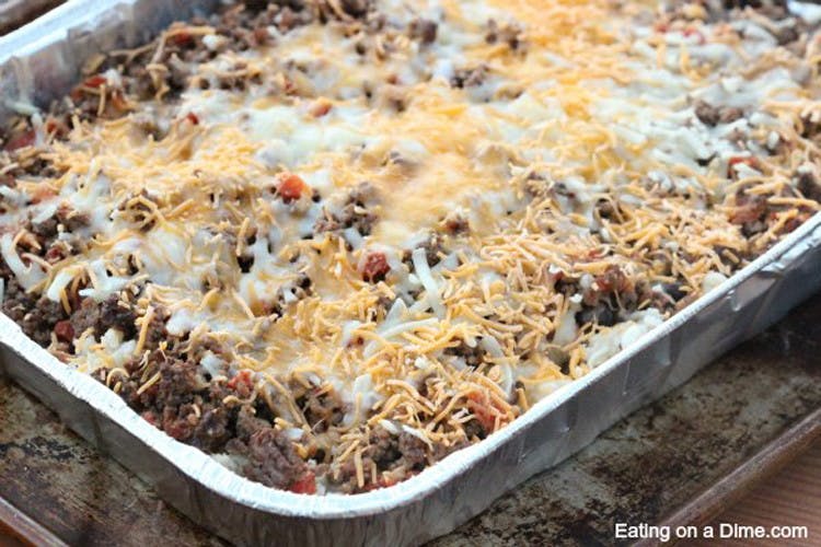 A large casserole dish with ground meat, cheese and other toppings