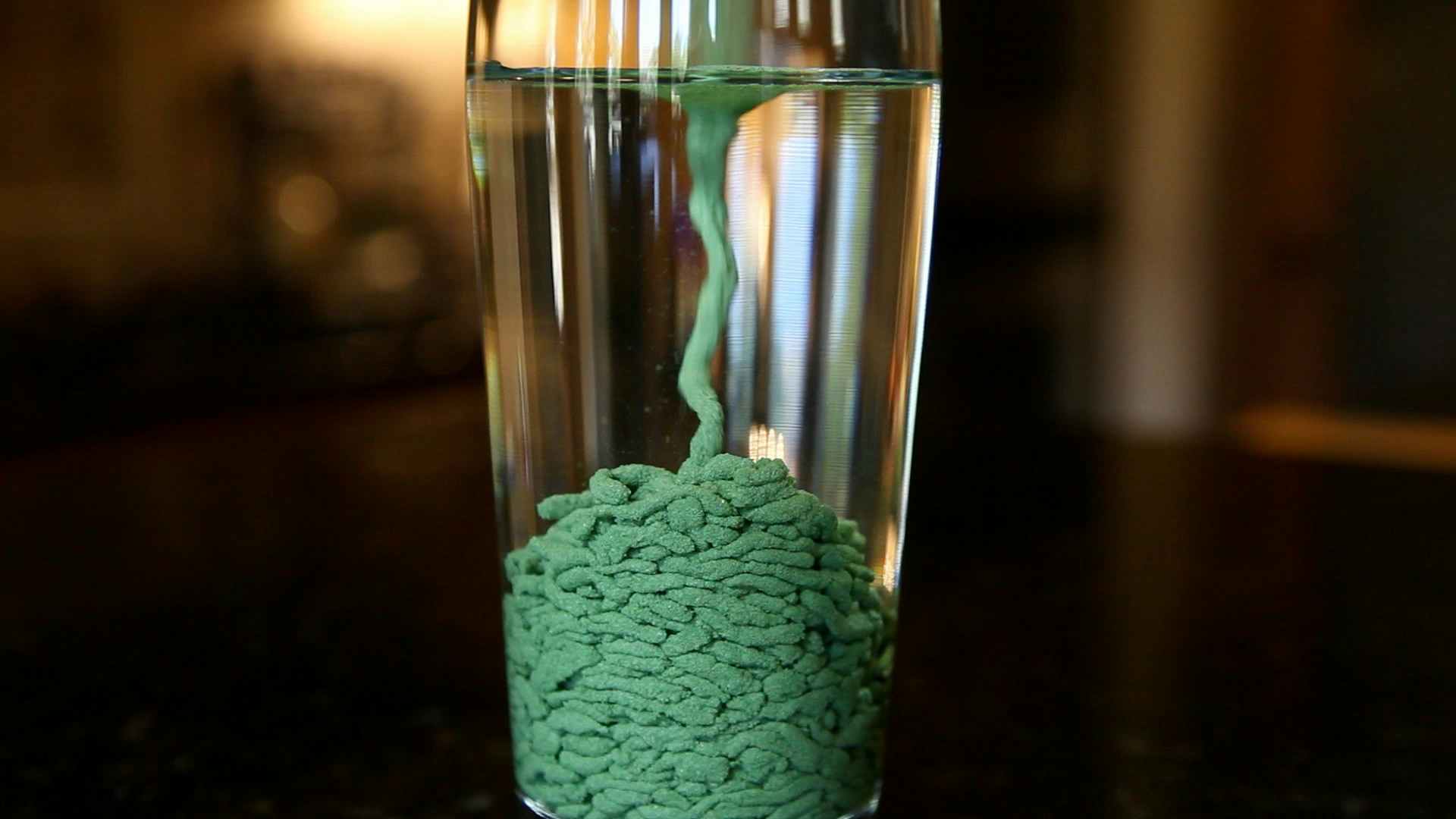a cup filled with water and waterproof sand 