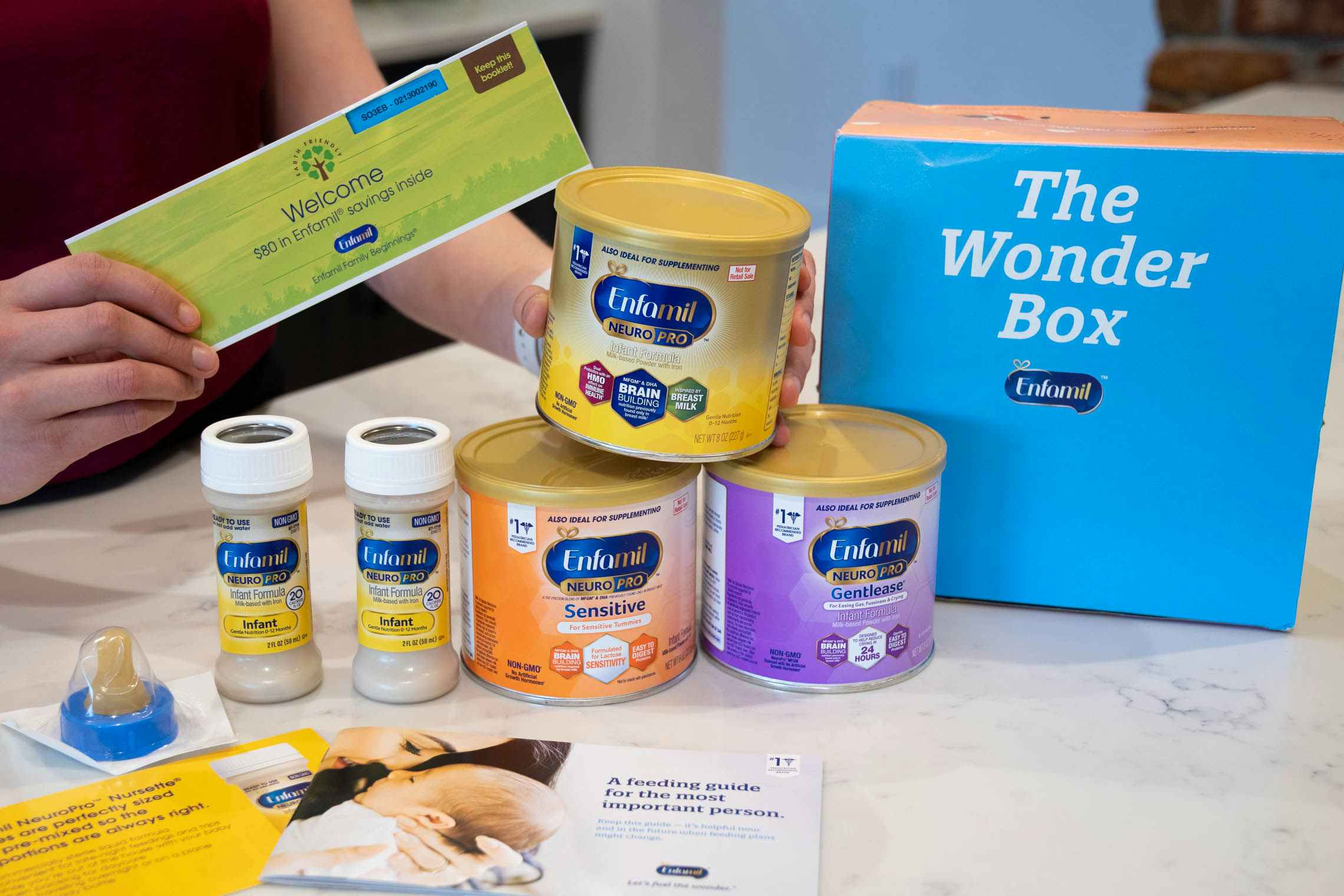 The Wonder Box, enfamil formula baby sample freebie box, sitting on a counter next to its contents.