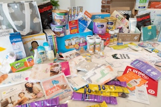 A large amount of baby products laid out on a counter top.