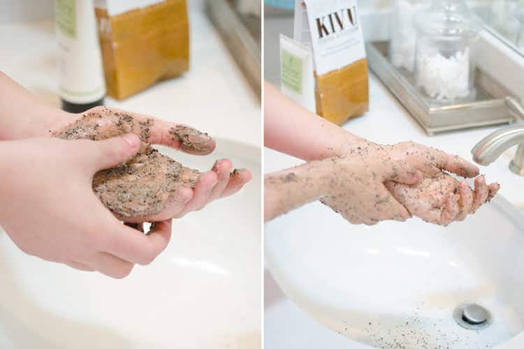 A person scrubbing their hands with coffee grounds.