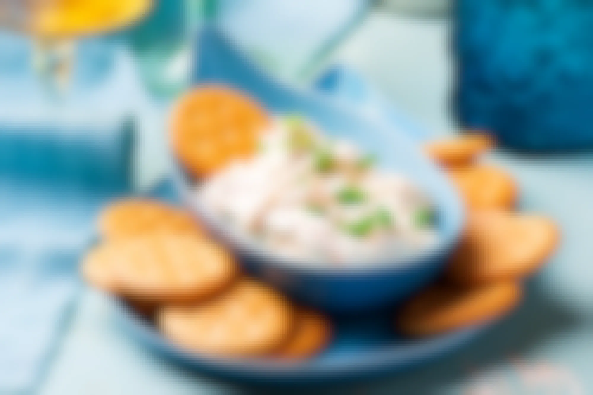 A bowl of french onion dip with crackers