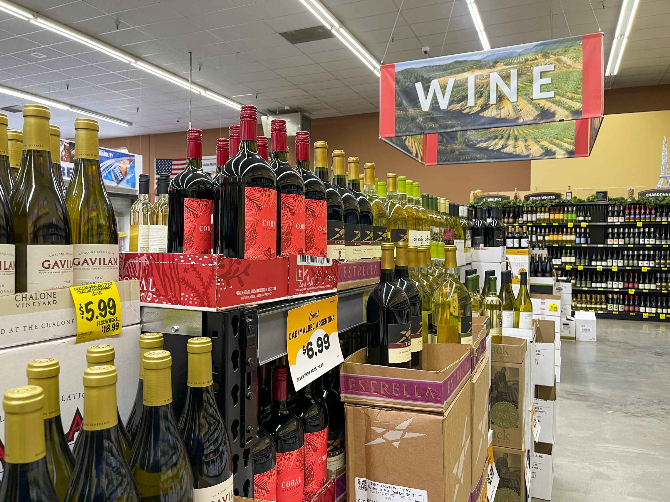 Bottles of Wine on shelves inside Grocery Outlet.