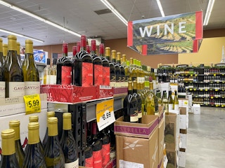 Bottles of Wine on shelves inside Grocery Outlet.