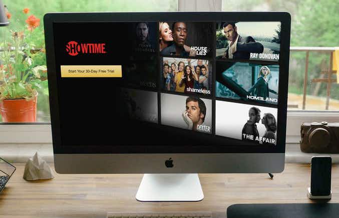 An iMac monitor displaying the Showtime website with a free trial button.