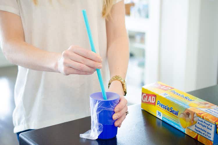 Prevent spills by covering a cup with plastic wrap.