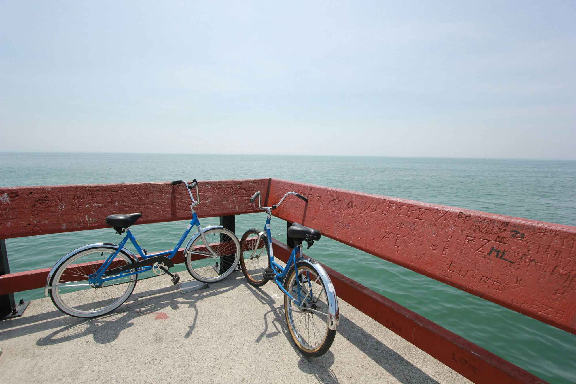 two bikes next to the ocean