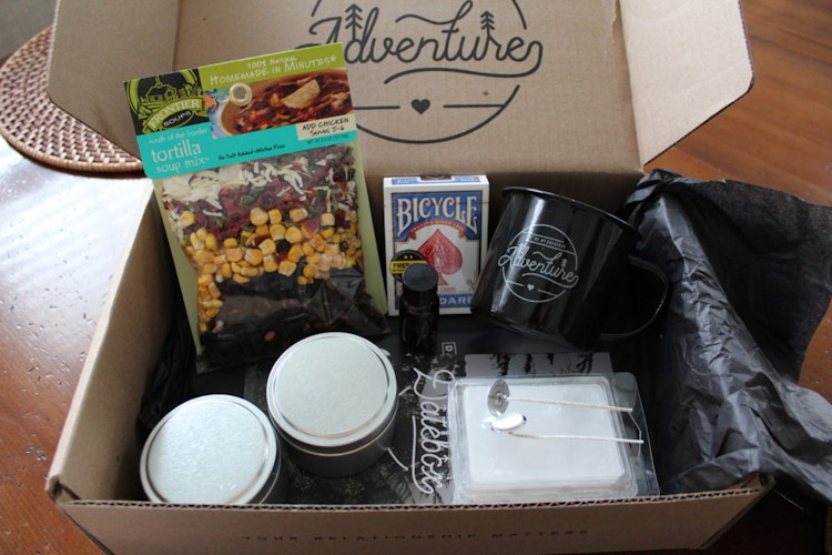 box with treats, cards and mug in it