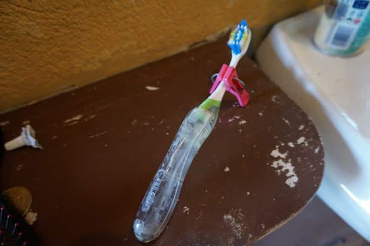 Keep toothbrushes off dirty counters with clothespins in a hotel room.