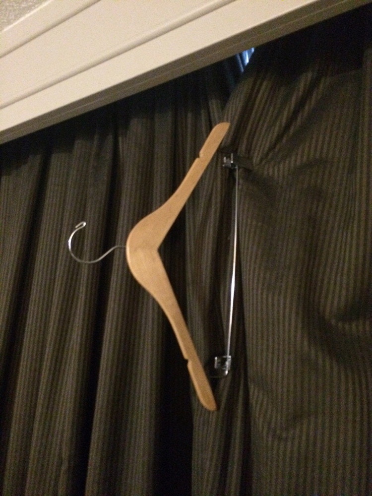 Keep the drapes shut and block unwanted light with the clips from a hanger.