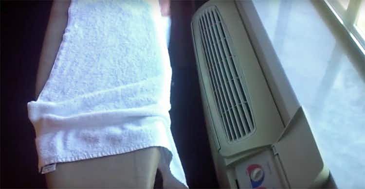 Place a damp towel near the hotel room A/C unit for a makeshift humidifier.