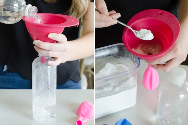 A person holding a funnel in the top of a bottle next to a person spooning something into a funnel.