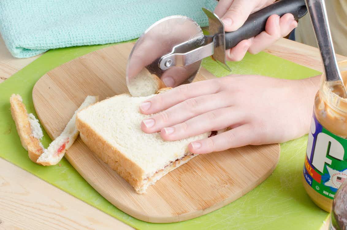 Slice the crusts off sandwiches with a pizza cutter