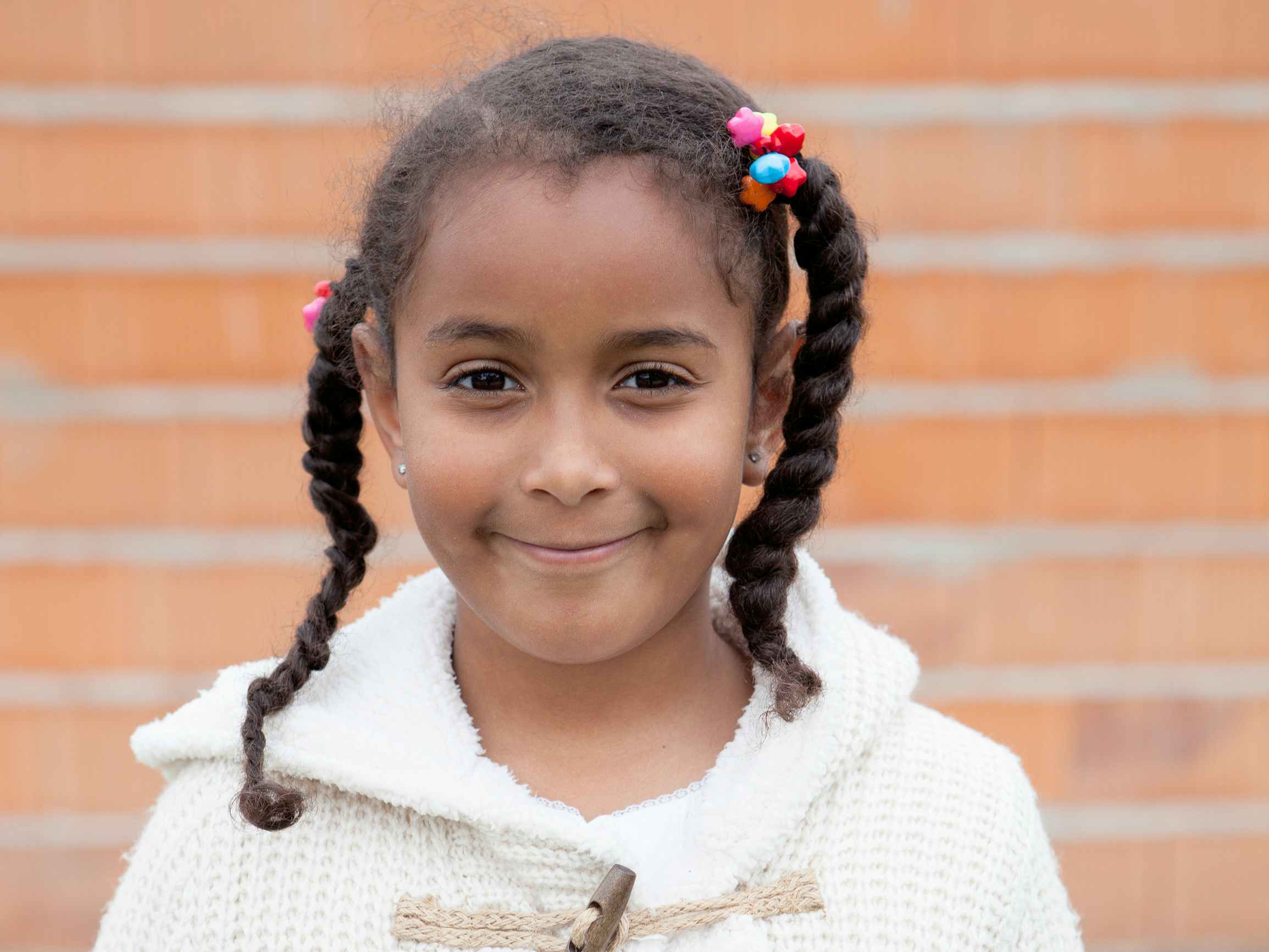 A young girl with asymmetrical ponytails