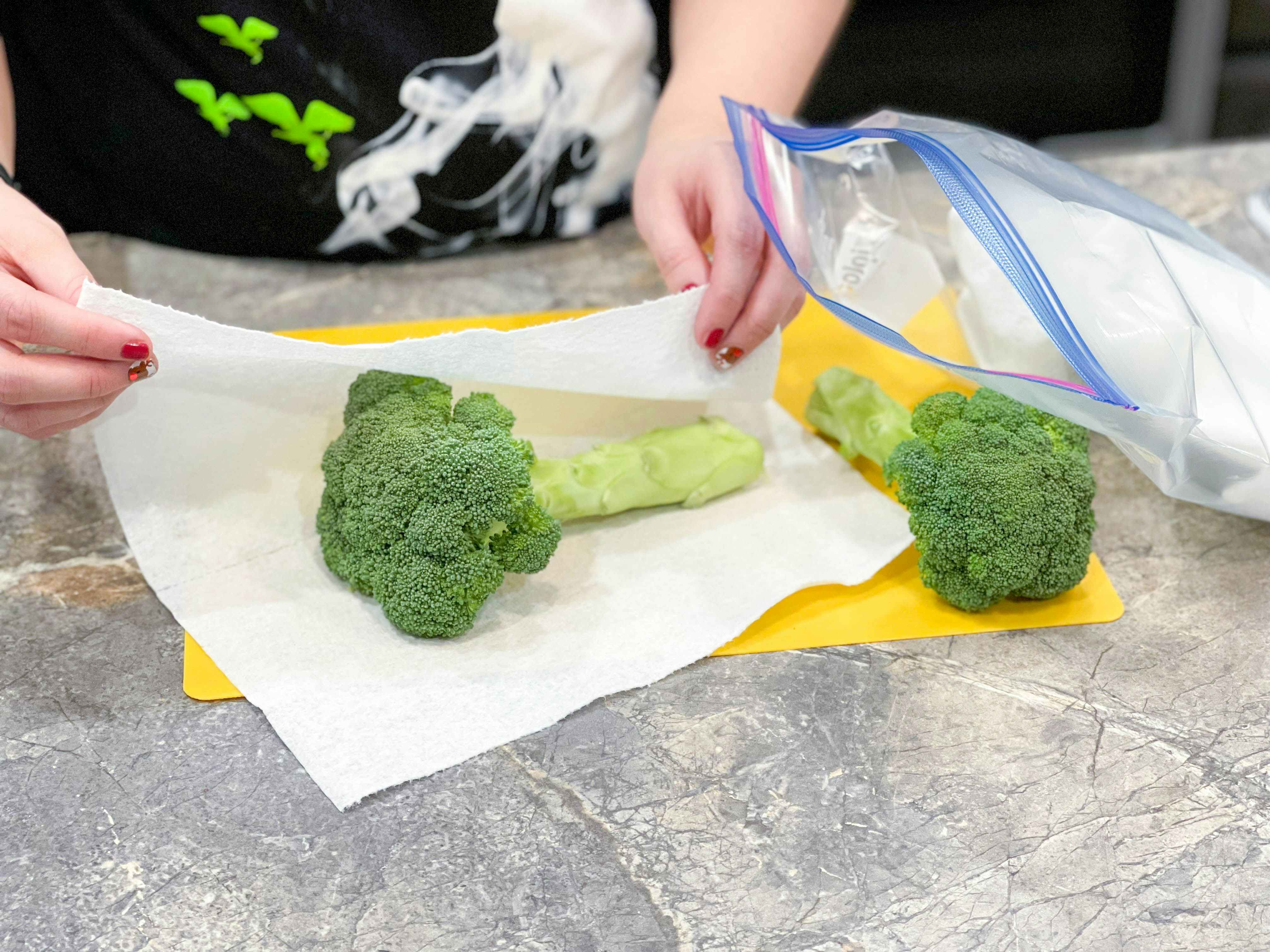 broccoli being wrapped in paper towel