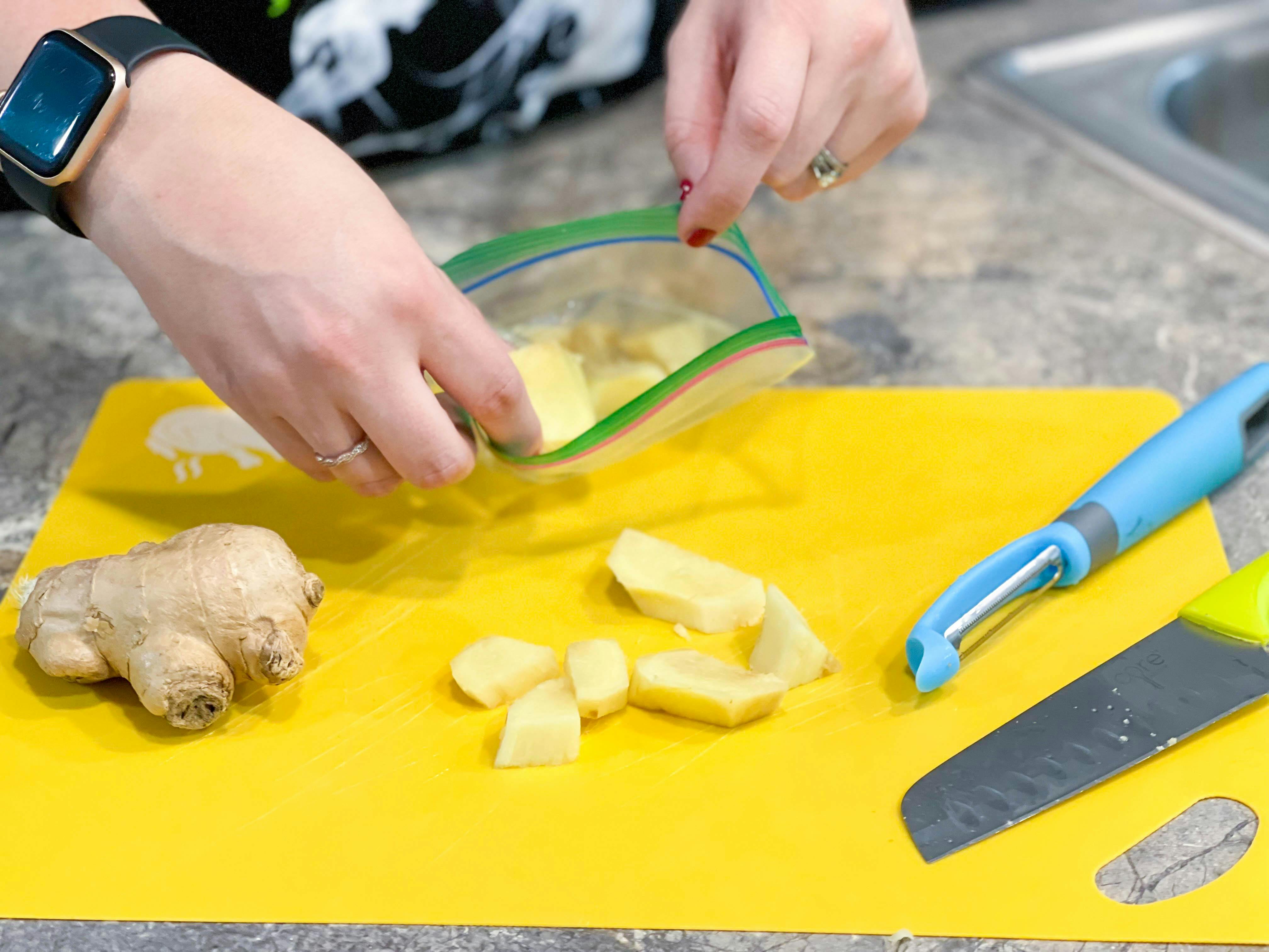 ginger peeled and cut being put in plastic bag