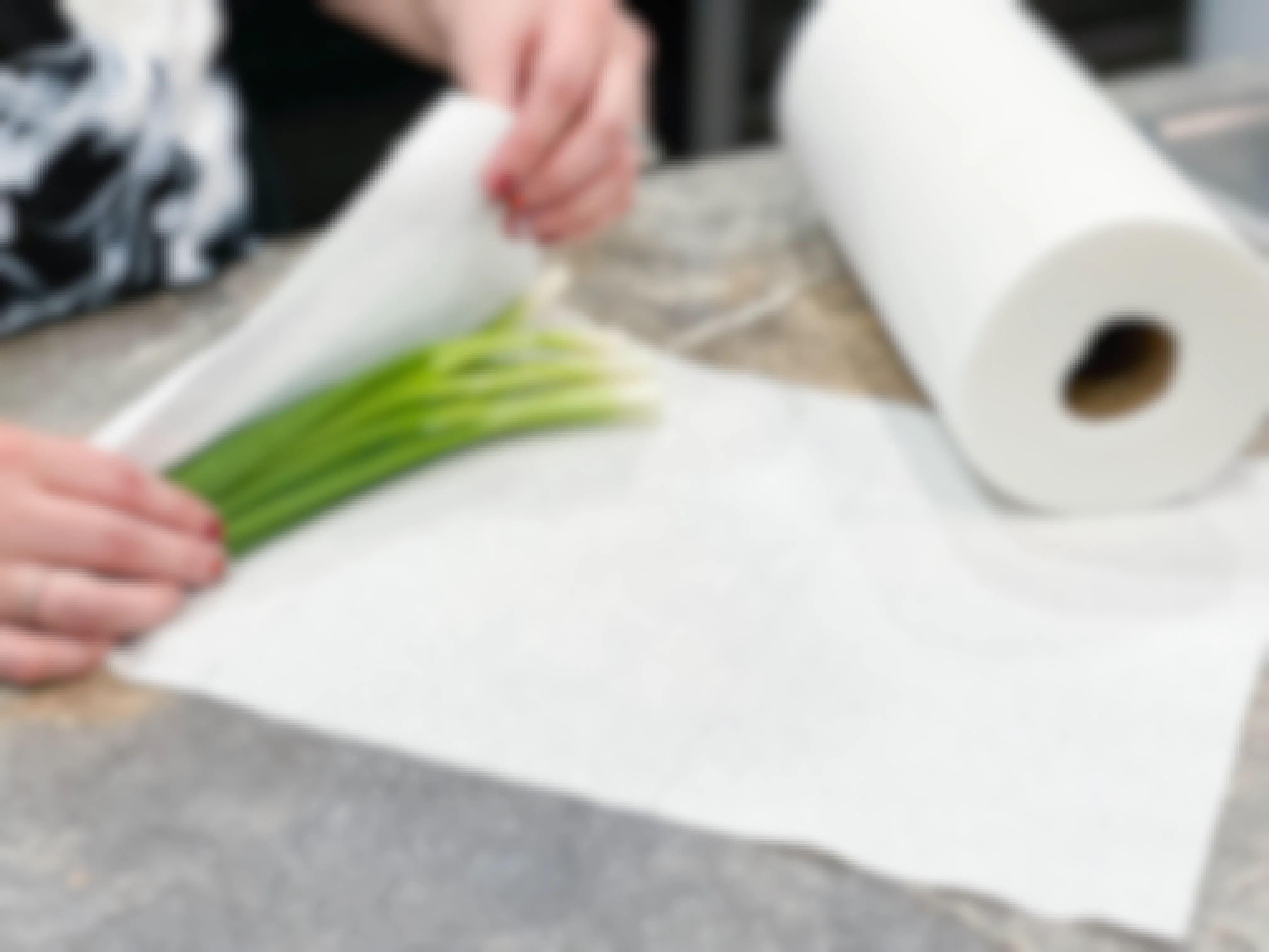 green onions being wrapped in paper towels