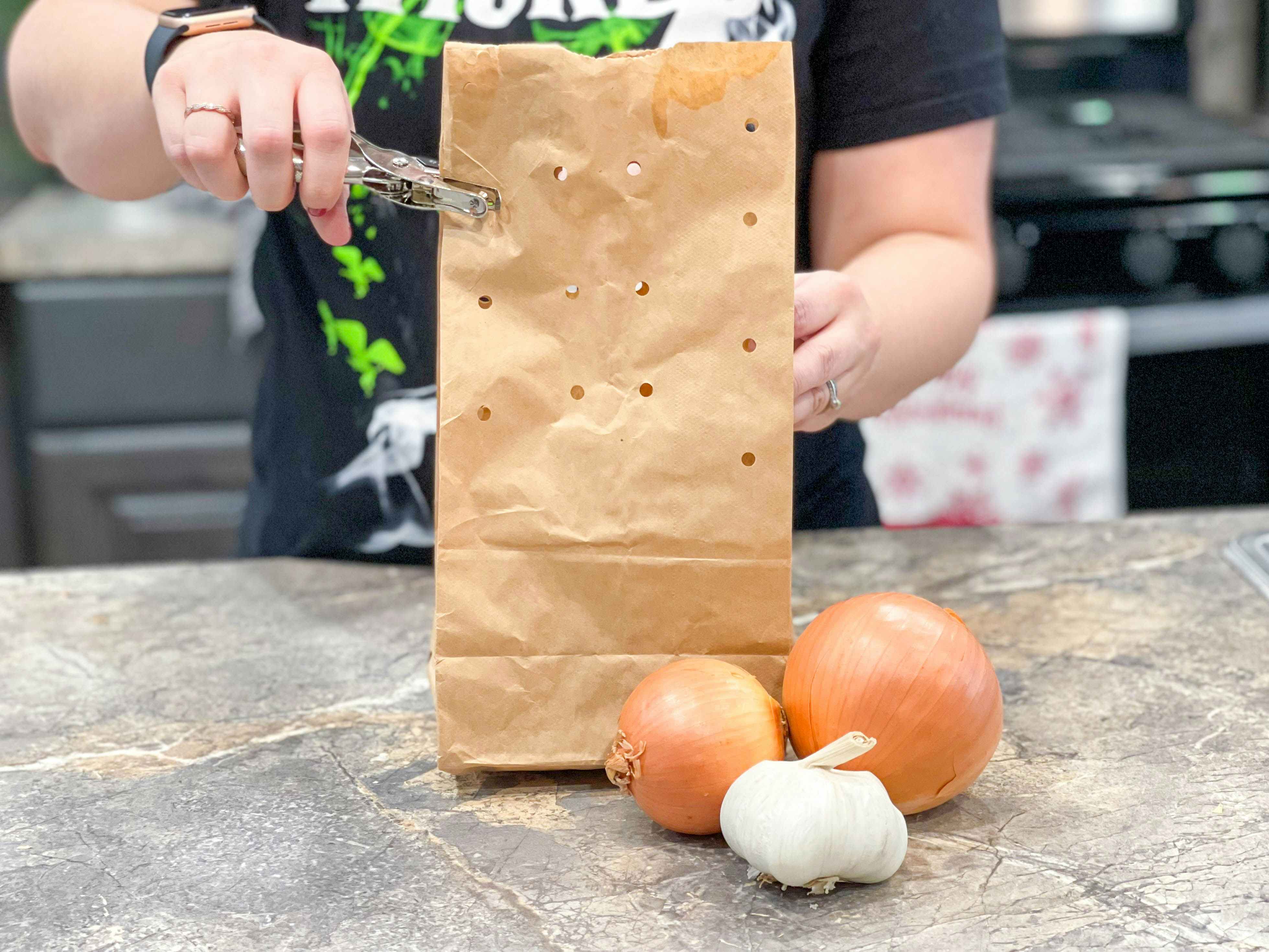 punching holes in paper bags for onions and garlic