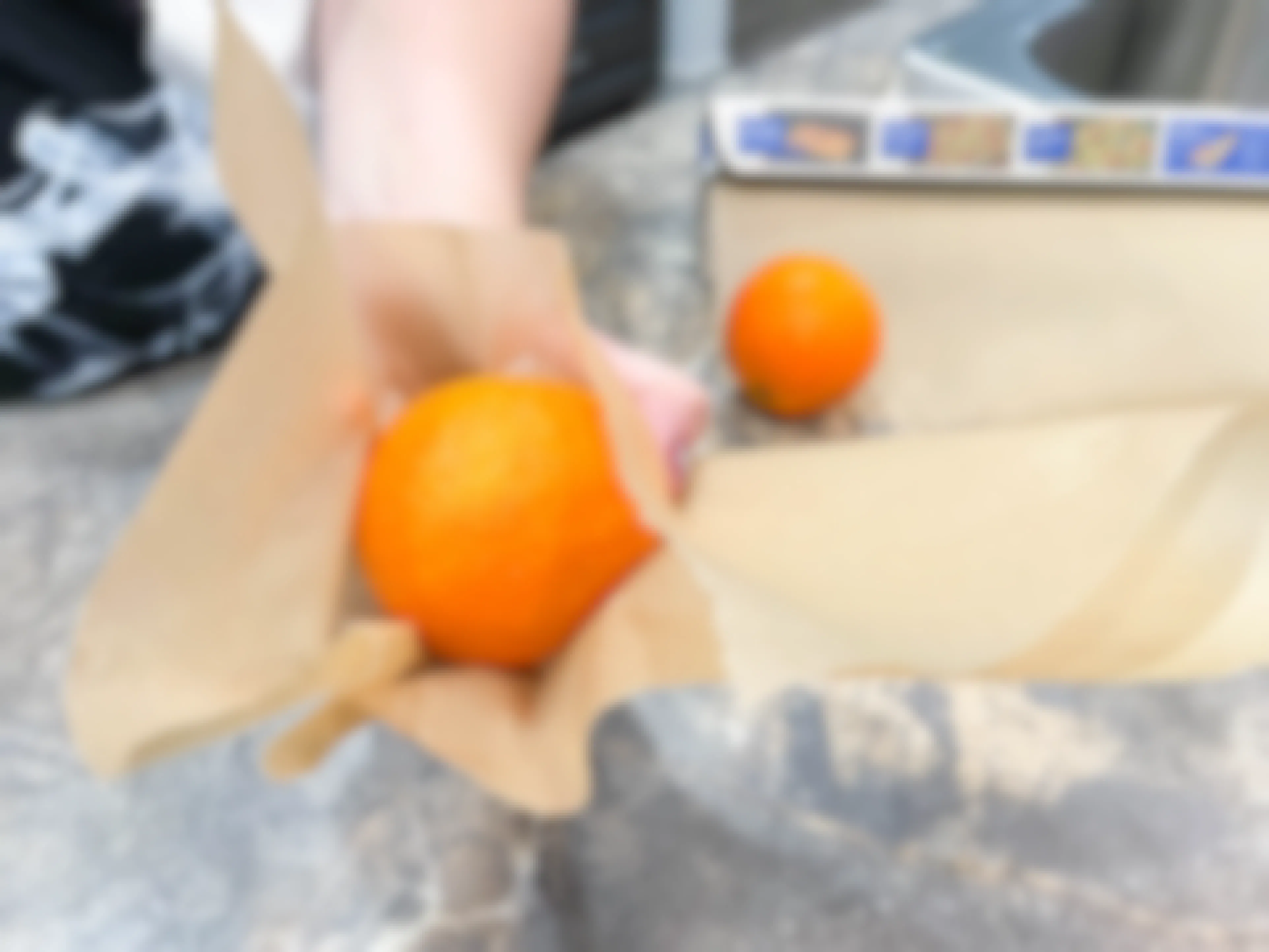 oranges being wrapped in parchment paper