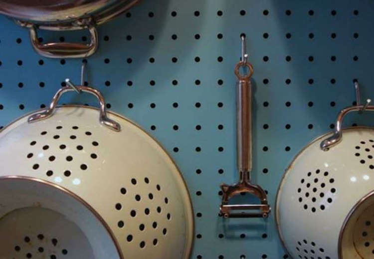 Hang kitchen items from a pegboard.