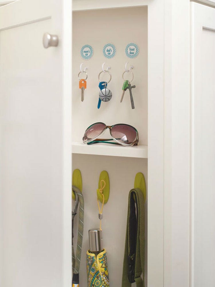 Add hooks in the cabinets nearest an entryway.