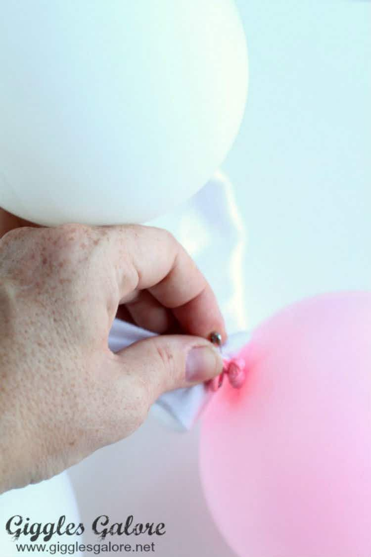 Pin white, clear, and pink balloons to a white outfit and go as a bubble bath.