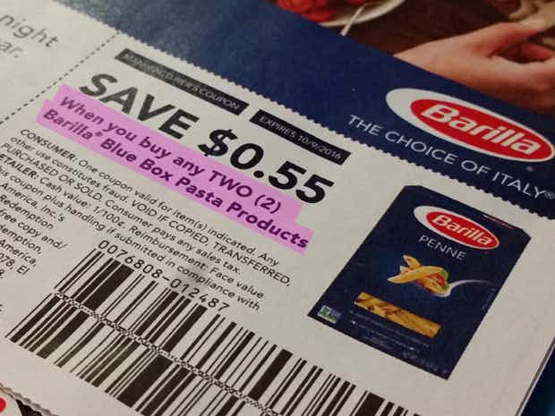a close up on a manufacturer coupon for Barilla that says " Save 55 cents when you buy any TWO Barilla Blue Box Pasta Products" that is highlighted in purple