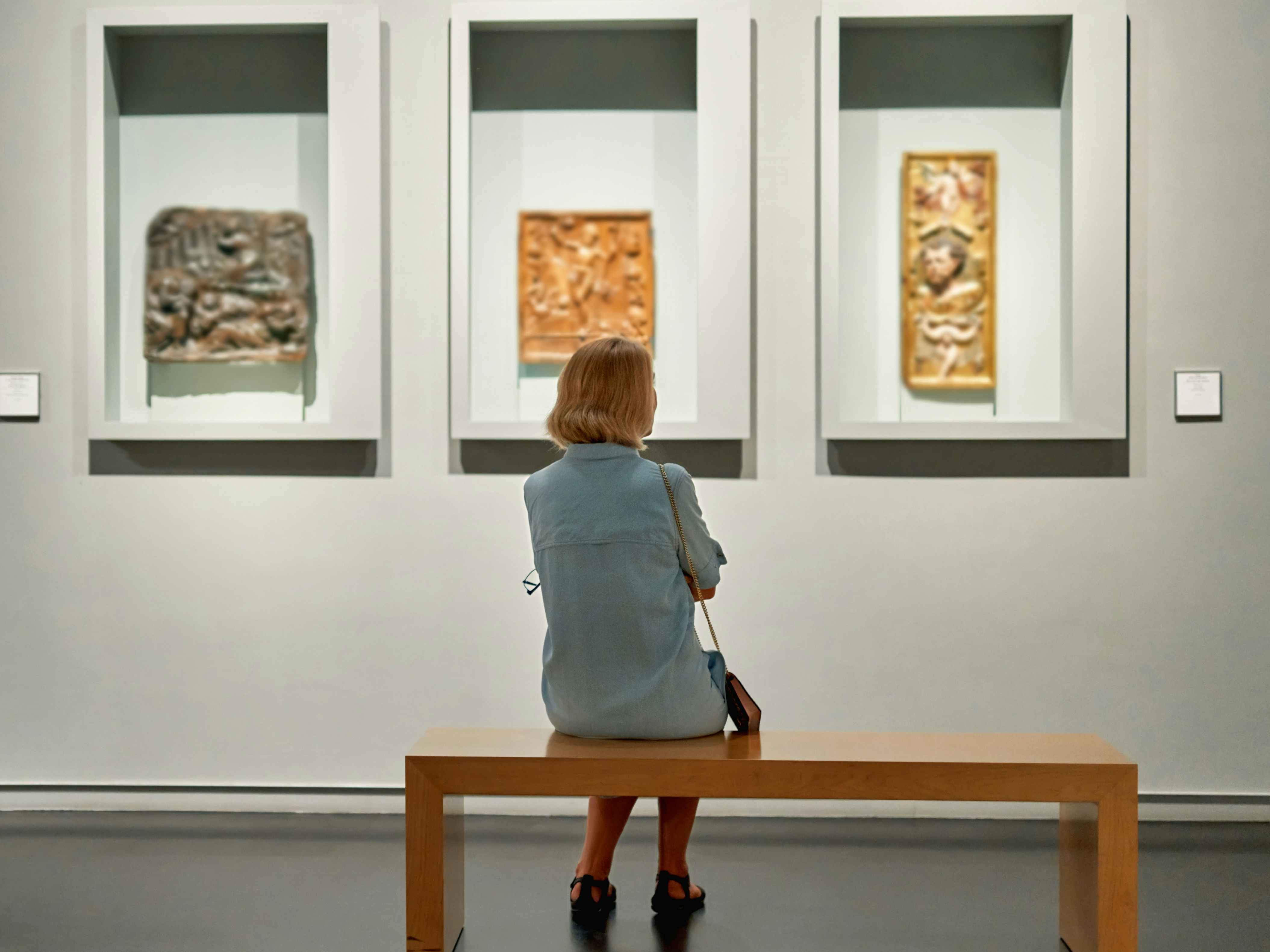 a person looking at an art object in a museum